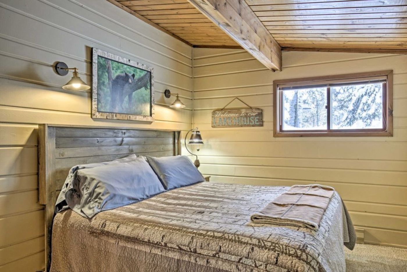 Bedroom with wood ceiling and wildlife art
